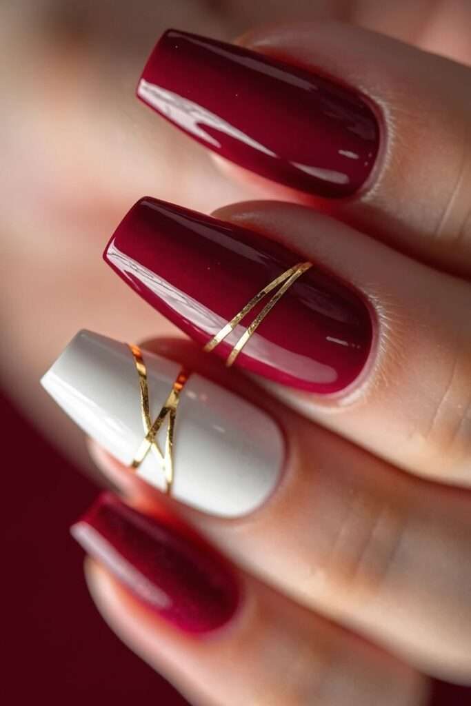 Luxury wine red and gold striped nails for winter fashion, elegant holiday nail idea for stylish women in the US